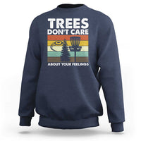 Navy crewneck sweatshirt with “Trees don’t care” graphic and trees scene.
