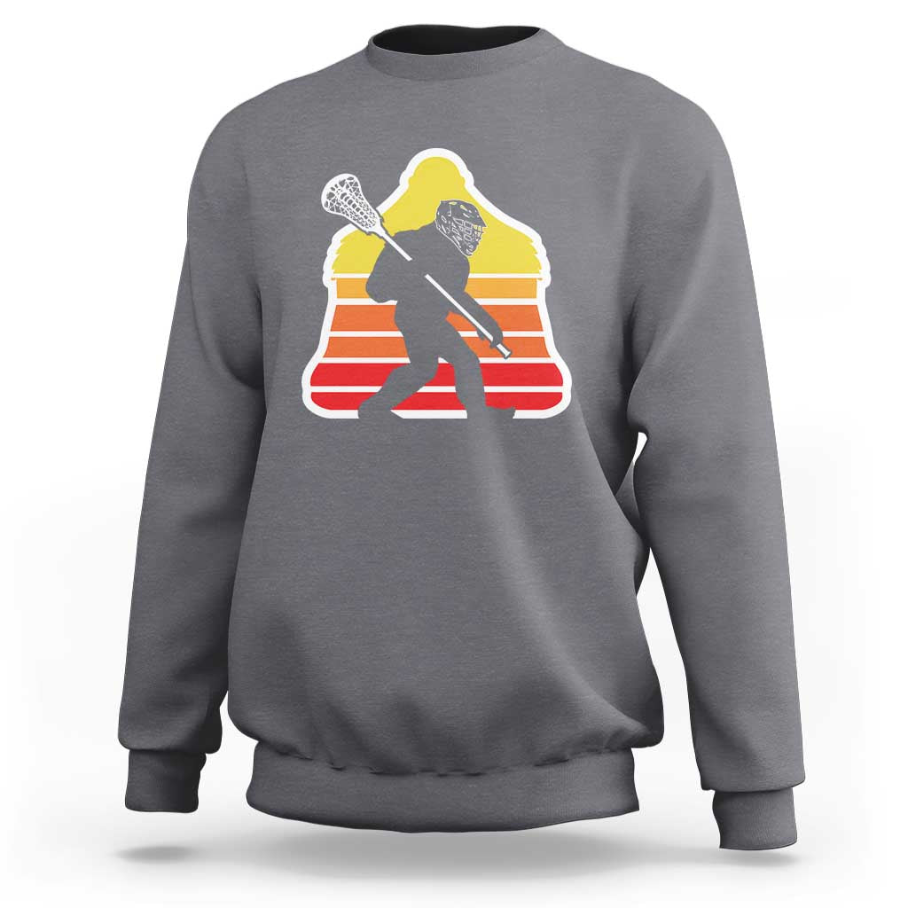 Gray crewneck sweatshirt with Bigfoot lacrosse player graphic on chest