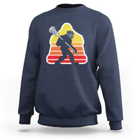 Heather-blue crewneck sweatshirt with Bigfoot lacrosse player graphic, centered