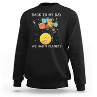 Black crewneck sweatshirt with space planets illustration and 'We Had 9 Planets' wording.