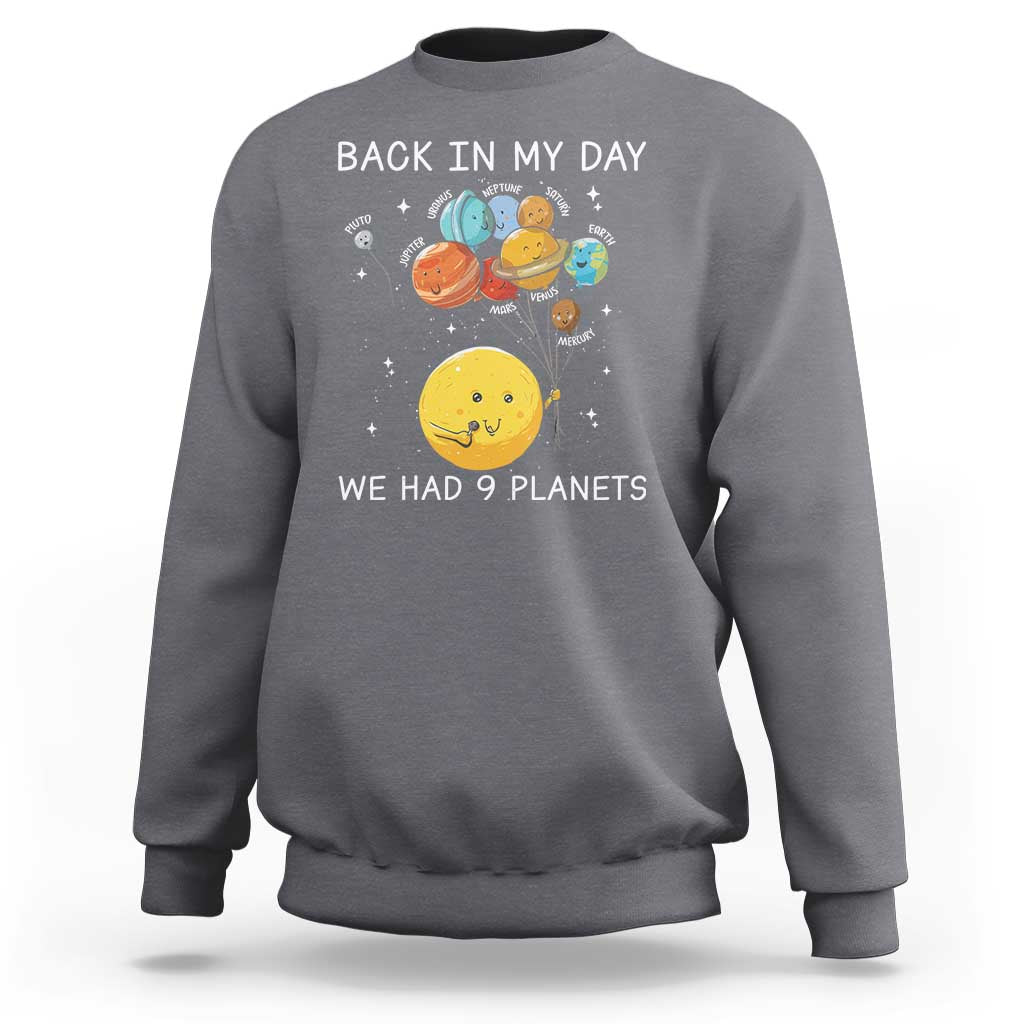 Gray crewneck sweatshirt with space planets graphic and 'We Had 9 Planets' text.