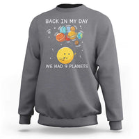 Gray crewneck sweatshirt with space planets graphic and 'We Had 9 Planets' text.