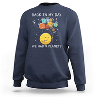 Dark blue crewneck sweatshirt with space planets graphic and text 'We Had 9 Planets'.