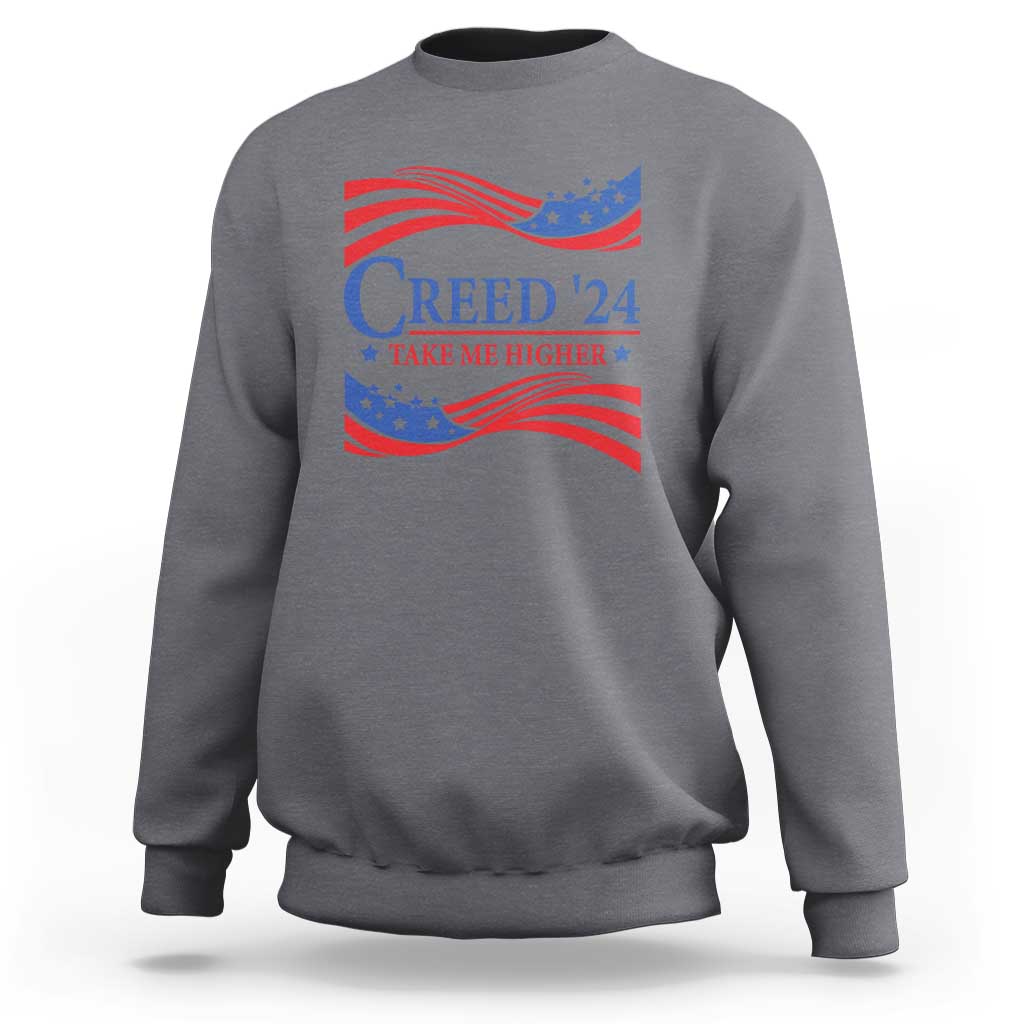Charcoal crewneck sweatshirt with patriotic “Creed '24” graphic and wavy flag print