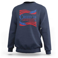 Navy crewneck sweatshirt with patriotic “Creed '24” graphic and wavy flag print