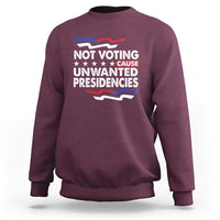 Maroon crewneck sweatshirt with 'NOT VOTING UNWANTED PRESIDENCIES' graphic