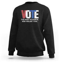 Black crewneck sweatshirt with VOTE graphic and “NON VIOLENT TOOL” text