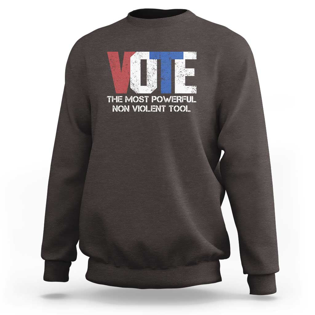 Dark brown crewneck sweatshirt with VOTE graphic and “NON VIOLENT TOOL” text