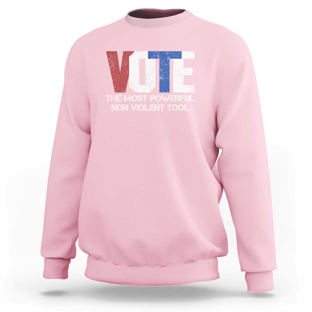 Light pink crewneck sweatshirt with VOTE graphic and “NON VIOLENT TOOL” text