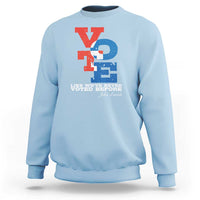 Light blue crewneck sweatshirt with "Like we've never voted before" printed graphic