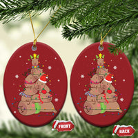 Red oval ornament set with capybara and nutcracker graphic, front and back tags
