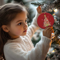 Hanging red round ornament with capybara and nutcracker graphic near a child