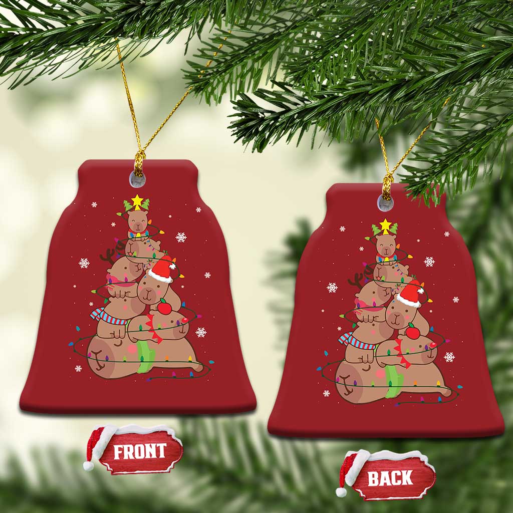 Red bell-shaped ornament with capybara and nutcracker graphic, front and back tags