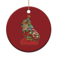 Red round capybara Christmas ornament with Merry Christmas text and gold hanging cord