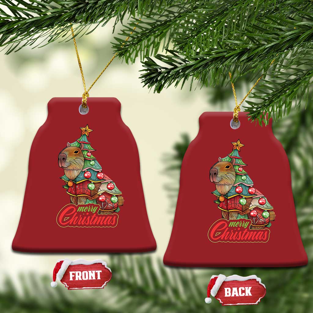 Pair of red bell-shaped capybara Christmas ornaments with Merry Christmas text and gold cords
