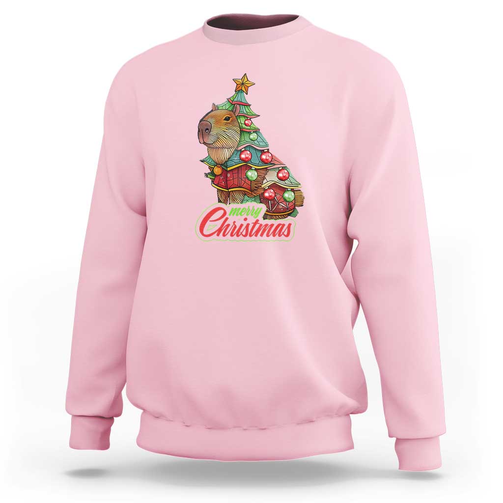 Light pink crewneck sweatshirt with capybara Christmas tree graphic and ribbed cuffs.