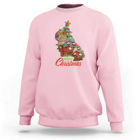 Light pink crewneck sweatshirt with capybara Christmas tree graphic and ribbed cuffs.