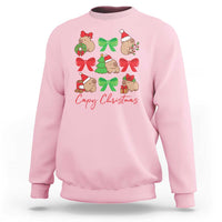 Light pink crewneck sweatshirt with capybara Christmas graphic and red bows