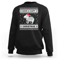 Black Christmas sweatshirt with capybara graphic and 'Have a Capy Christmas' text.