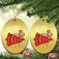 Two gold oval capybara ornaments with red art and 'DON'T WORRY BE CAPPY' text, front/back tags