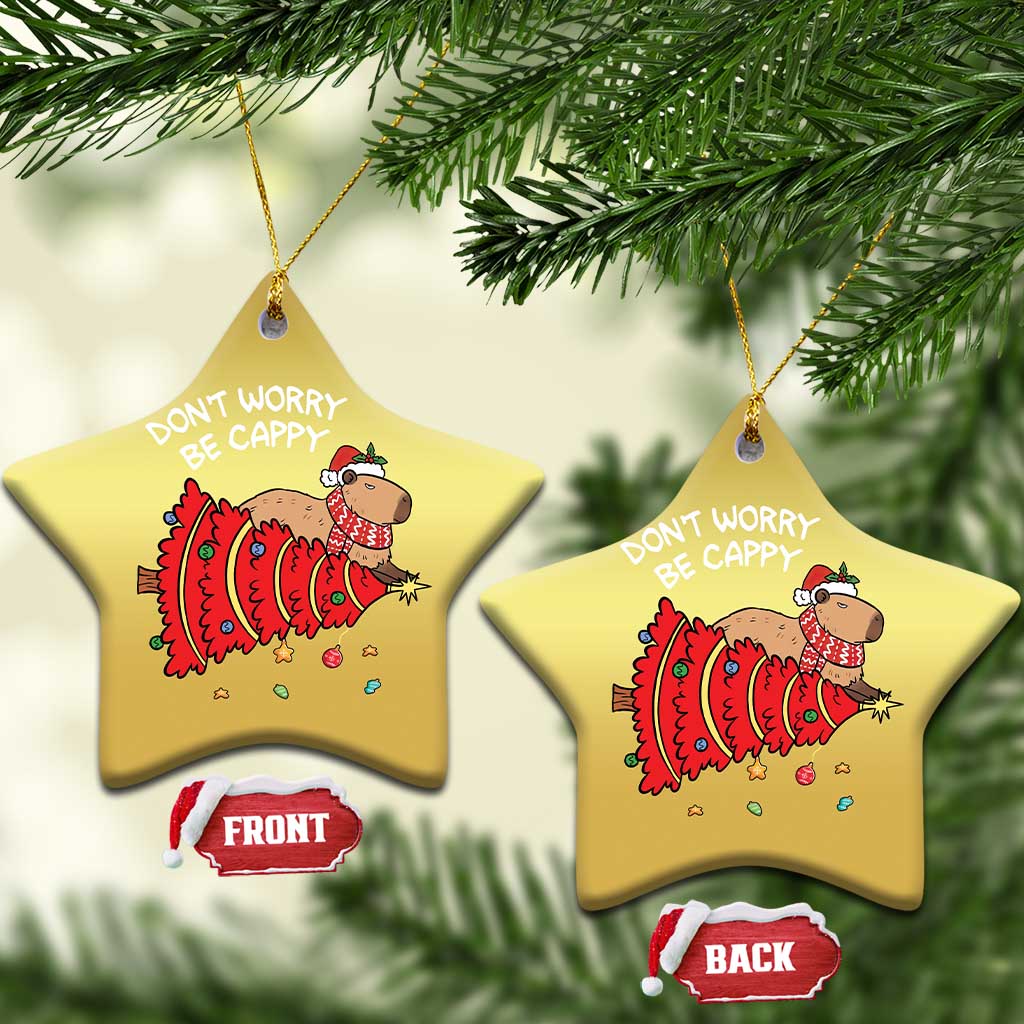 Two gold star-shaped capybara ornaments with red artwork and 'DON'T WORRY BE CAPPY' text