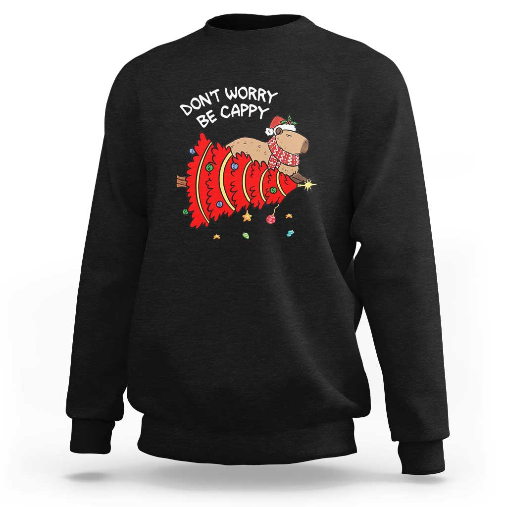 Black Christmas capybara sweatshirt with “Don’t Worry Be Capy” graphic on chest
