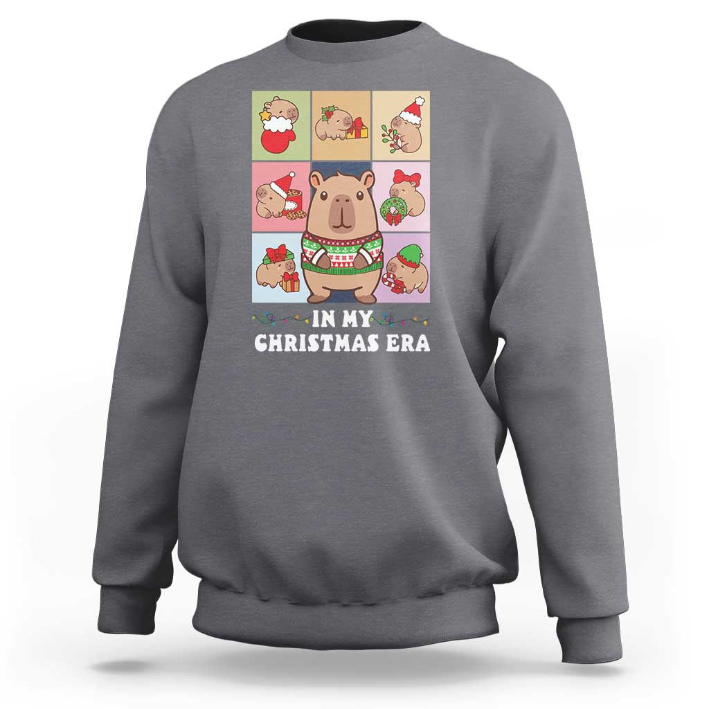 Charcoal gray Christmas sweatshirt with capybara graphic and “IN MY CHRISTMAS ERA” text.