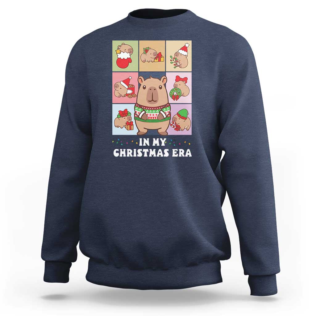 Navy Christmas sweatshirt with capybara graphic and “IN MY CHRISTMAS ERA” text.