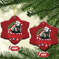 Two red star-shaped opossum Christmas ornaments hanging on a tree