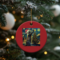Red round raccoon Christmas ornament hanging from a tree branch