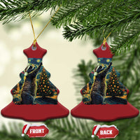 Two red Christmas tree-shaped raccoon ornaments with hanging loops, front and back