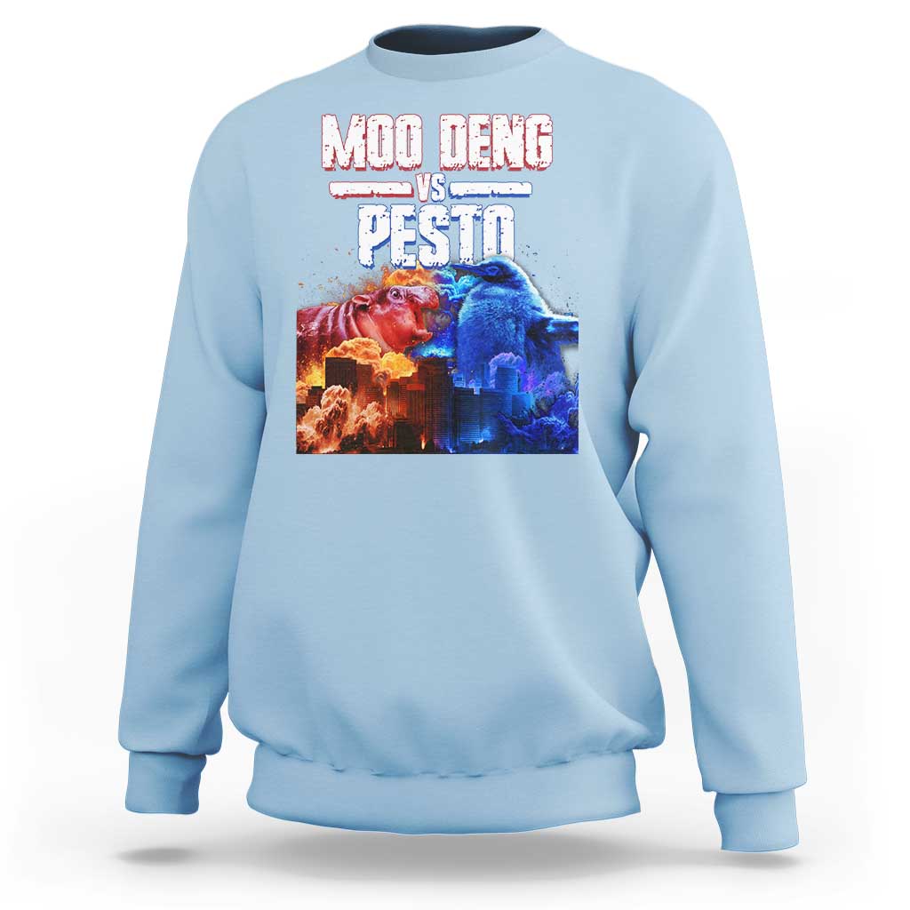 Light blue crewneck sweatshirt with colorful “MOO DENG VS PESTO” graphic on chest