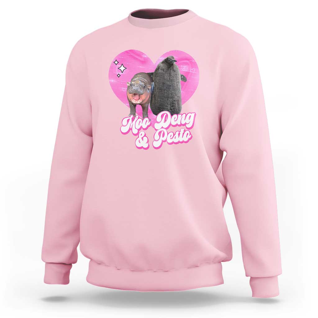 Light pink graphic sweatshirt with pink heart logo and Moo Deng & Pesto lettering