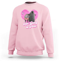 Light pink graphic sweatshirt with pink heart logo and Moo Deng & Pesto lettering