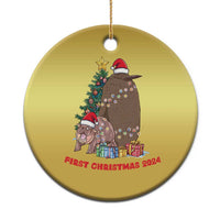 Gold round Christmas ornament with cartoon nativity animals, Santa hats, and 'First Christmas 2024'