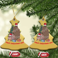 Gold bell-shaped Christmas ornaments hanging, cartoon nativity animals and 'First Christmas 2024'
