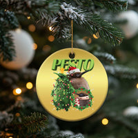 Gold circle Christmas ornament with PESTO text, penguin, decorated wreath, and gift
