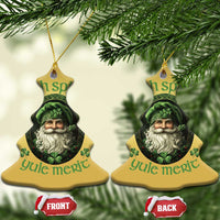 Two gold bell-shaped Christmas ornaments with green leprechaun portrait hanging on branches