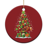 Red round Irish Christmas ornament with illustrated Christmas tree, candles, and shamrocks.