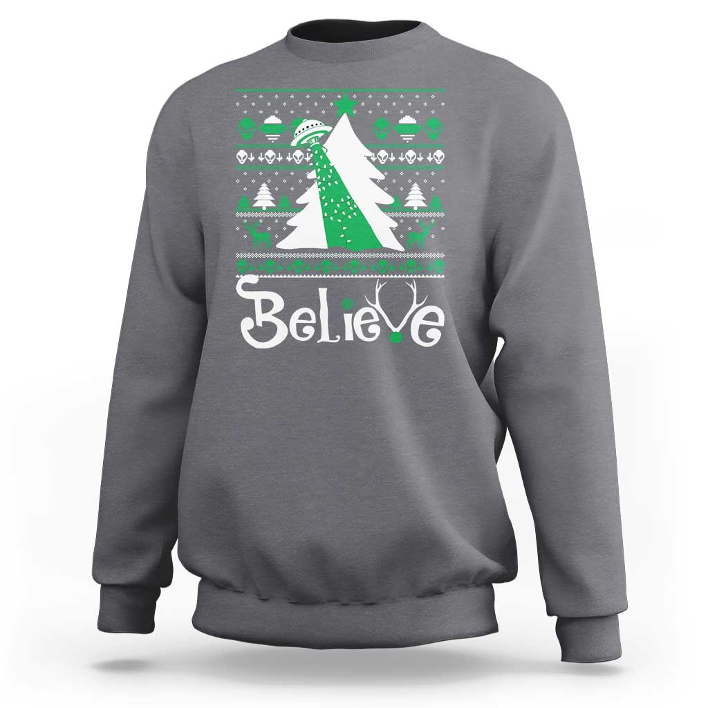 Gray crewneck sweatshirt with festive 'Believe' print and green bow UFO graphic