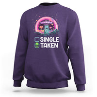 Purple crewneck sweatshirt with 'SINGLE TAKEN' alien UFO Valentine graphic