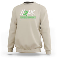 Sand-colored kidney disease awareness sweatshirt with Hope ribbon graphic on chest