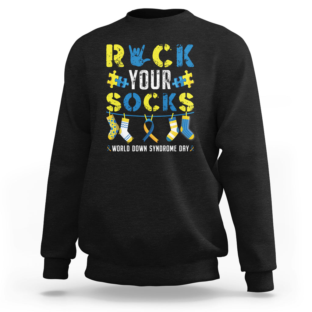 Black crewneck sweatshirt with colorful “Rock Your Socks” sock graphic on back