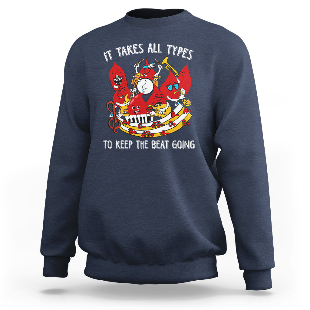 Navy crewneck sweatshirt with colorful music-themed graphic and slogan on chest.