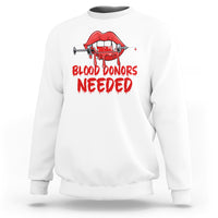 White crewneck sweatshirt with red vampire lip graphic and “BLOOD DONORS NEEDED” print