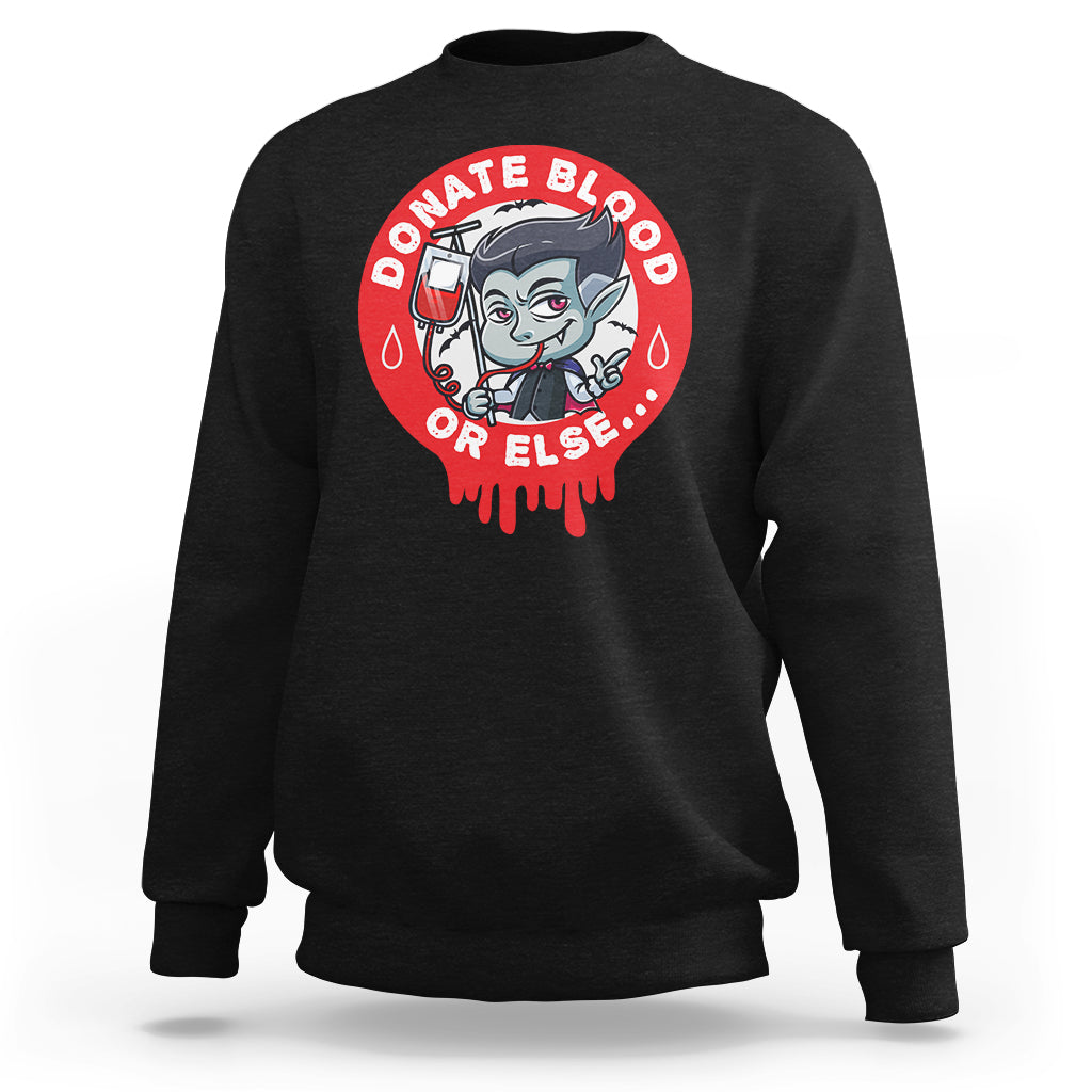 Black crewneck sweatshirt with red vampire blood-donor graphic on the back.
