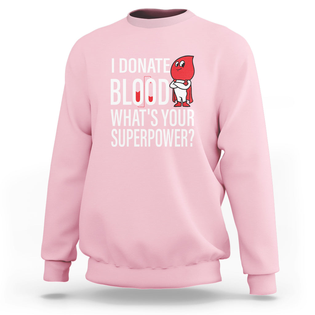 Light pink crewneck sweatshirt with front print: “I Donate Blood What’s Your Superpower?”
