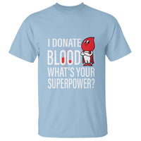 Light blue blood donation T-shirt with red character and 'superpower' slogan