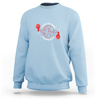Light blue crewneck sweatshirt with red heart donor graphic on the front