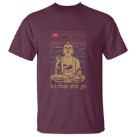 Maroon crew-neck T-shirt with seated Buddha graphic and red/blue line backdrop